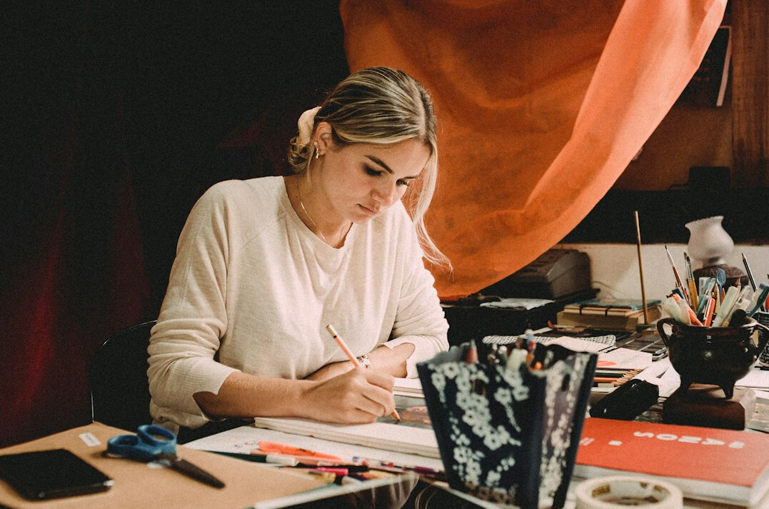 writer at desk with notes